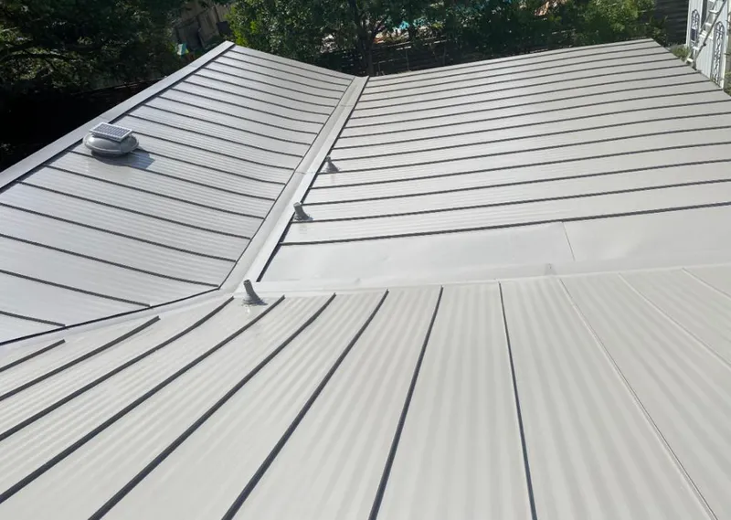 Solar attic fan installed on a metal roof for Roof Ventilation in Columbus